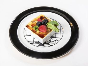 Creme brulee topped with fresh berries on the Avanti plate