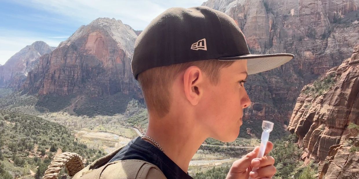 picture of man hiking using hydration tube