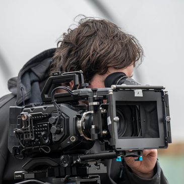 A picture of James McAllister, a director of We Film Blackpool operating a camera