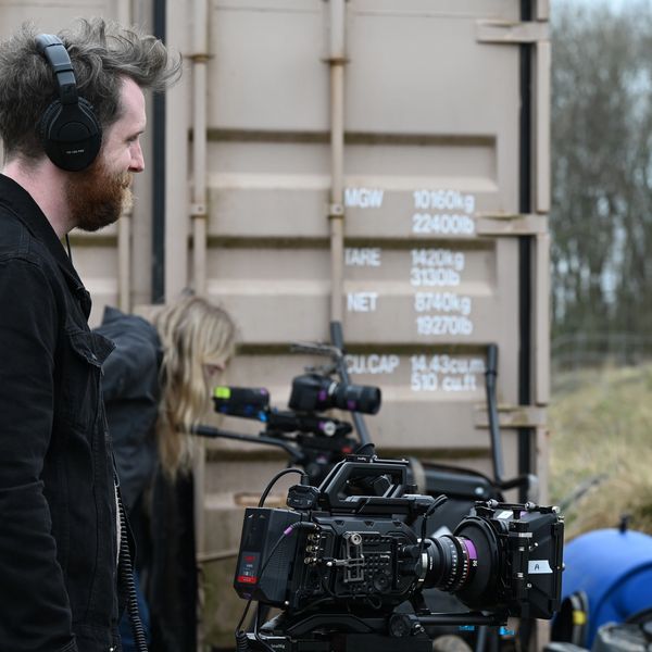 Film crew on set manning cameras during a video production