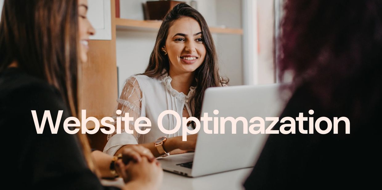 Three women discussing website optimization around a laptop.