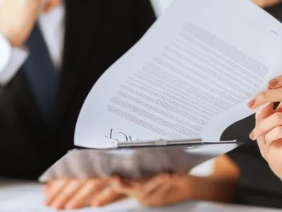 Person reviewing documents in a professional setting.