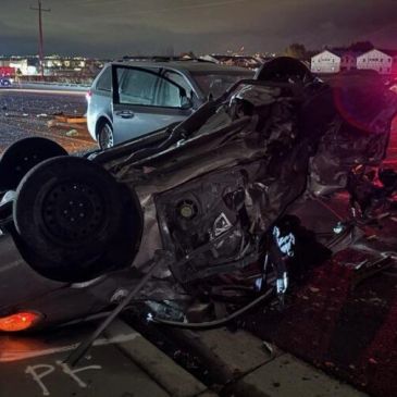 Overturned car after a severe crash at night.