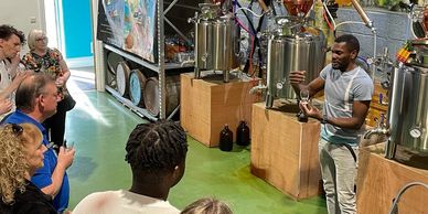 Group of People listening to Sylvester Herman of IslandSlice distillery. 