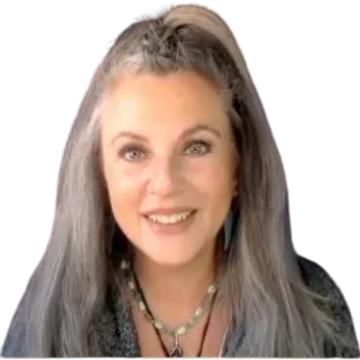 Smiling woman with long gray hair and bright eyes.