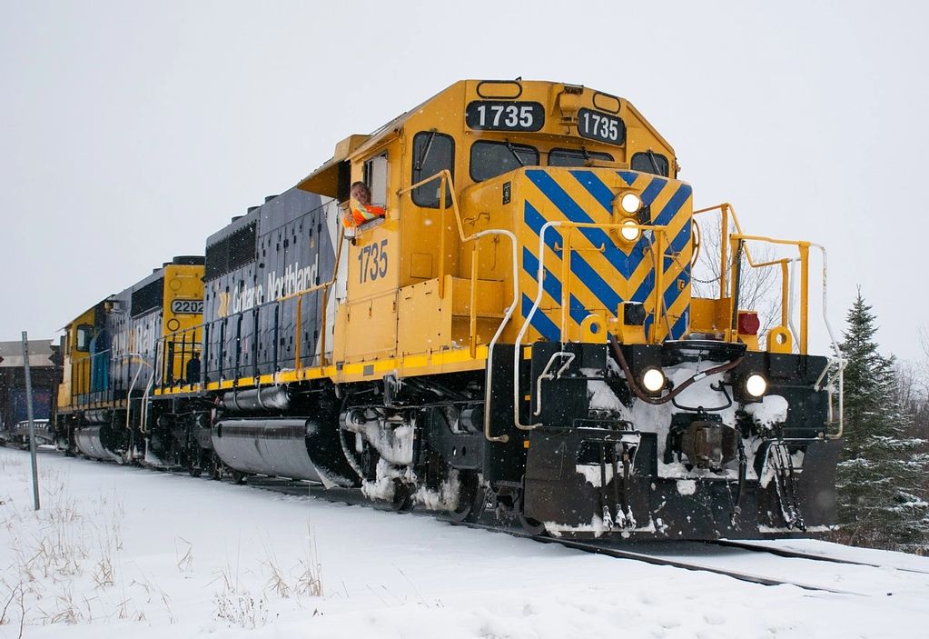 Engineman Arnold gives a big smile and a thumbs up from the cab of SD40-2 1735 as his train rolls in