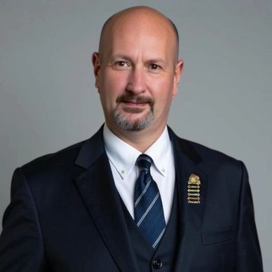 Professional man in suit with a pin on his lapel.