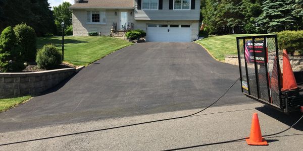 Asphalt sealcoating