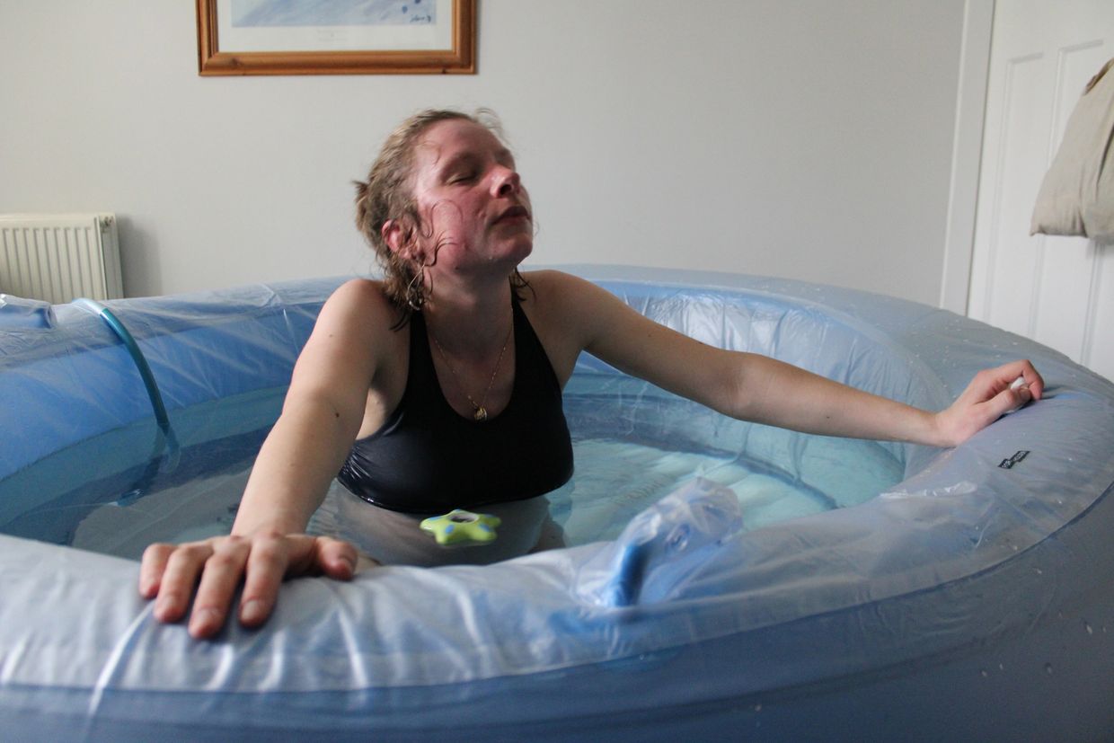 Picture of Rose of The Birthing Well having a waterbirth using hypnobirthing tecniques