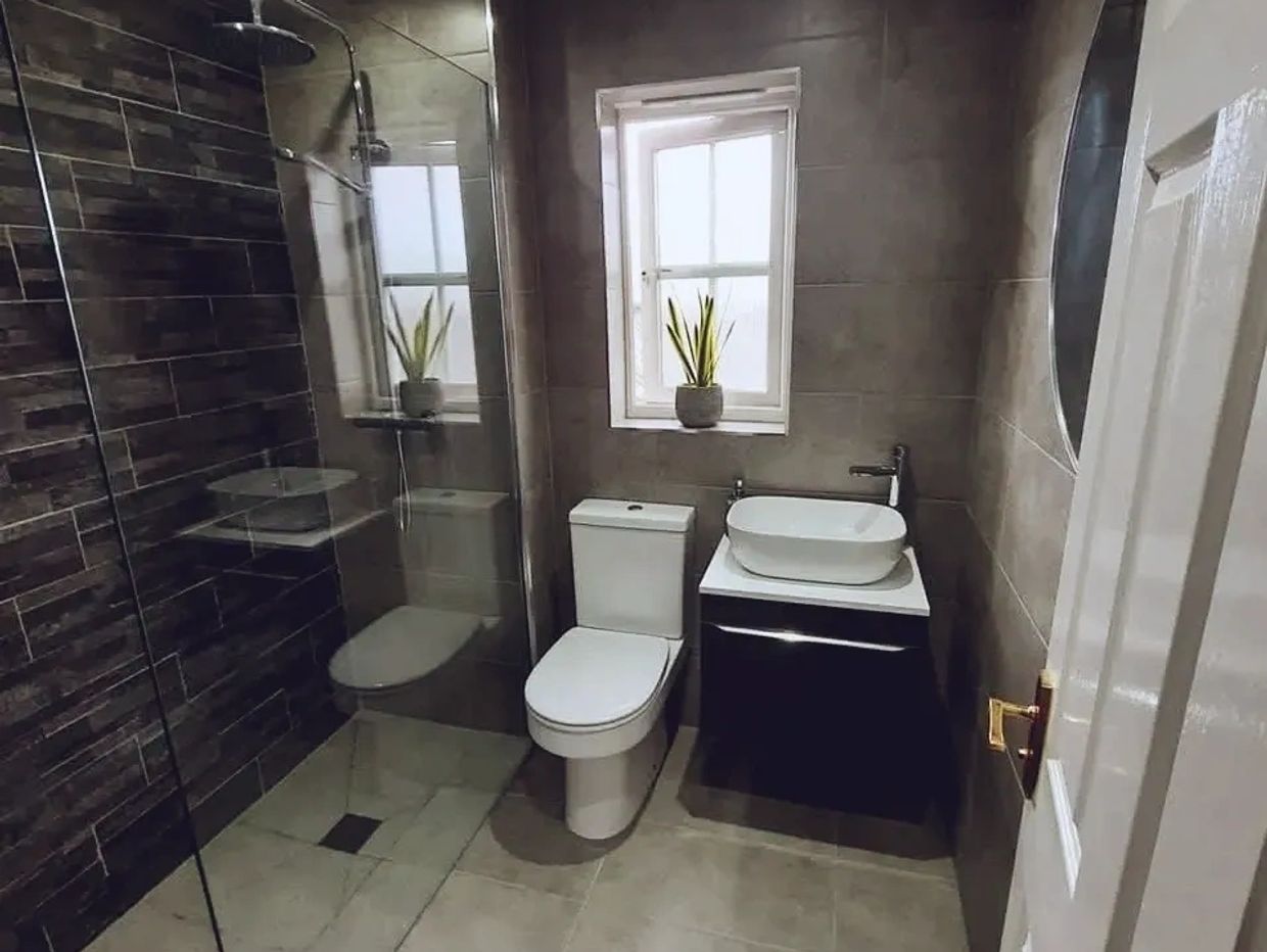 Modern bathroom with glass shower and minimalist design.