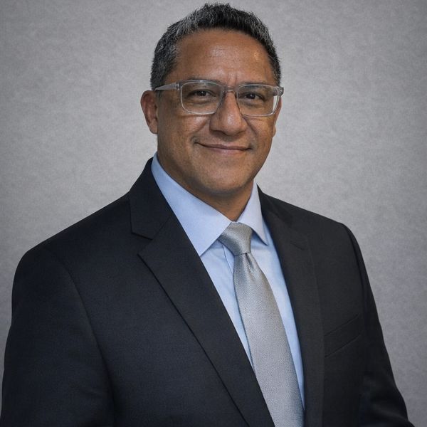Professional man in suit and tie smiling confidently.