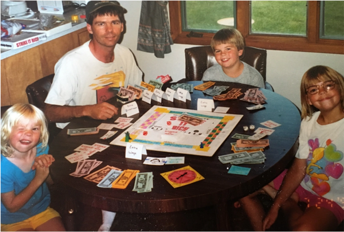 Family playing an early version of Strike It Rich board game in 1998.
