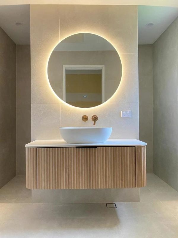 Cassa Design V-Groove Curved Single Bowl Wall Hung Vanity with Round Touchless LED mirror.