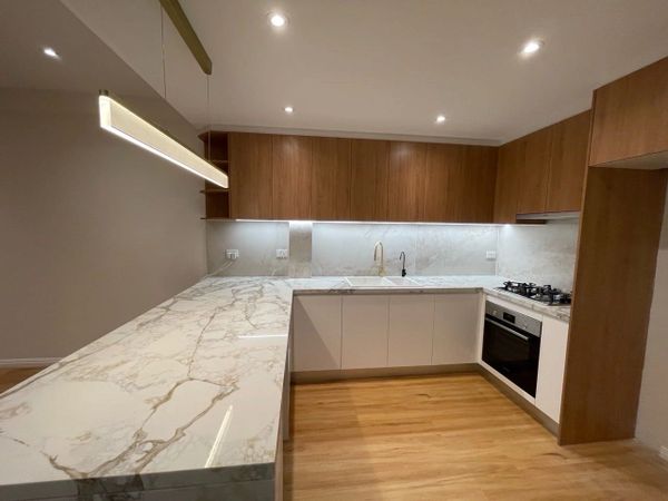 Hybrid Flooring in Blackbutt. The wall cabinets are Polytec Matt in Tasmanian Oak.