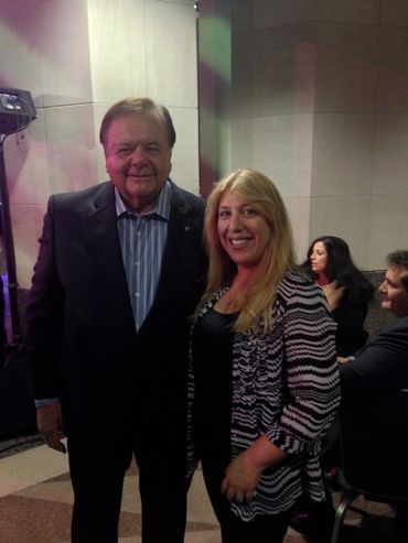 A man and woman posing together indoors.