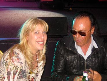 Two people sitting together, smiling and talking.