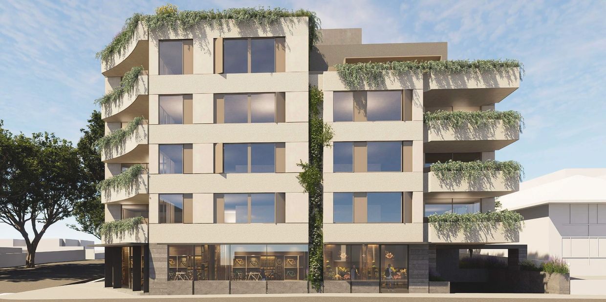 Modern apartment building with greenery on balconies and facade.