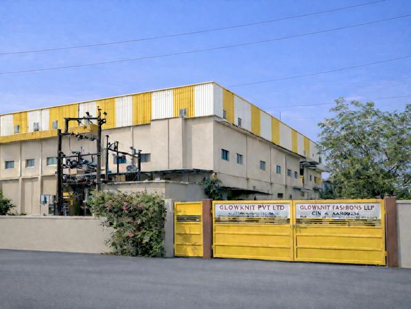 Industrial building with yellow and white exterior and yellow gates.