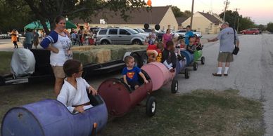 Kids dressed up for halloween riding in a train.