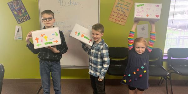 Kids in Sunday school showing off their creations.