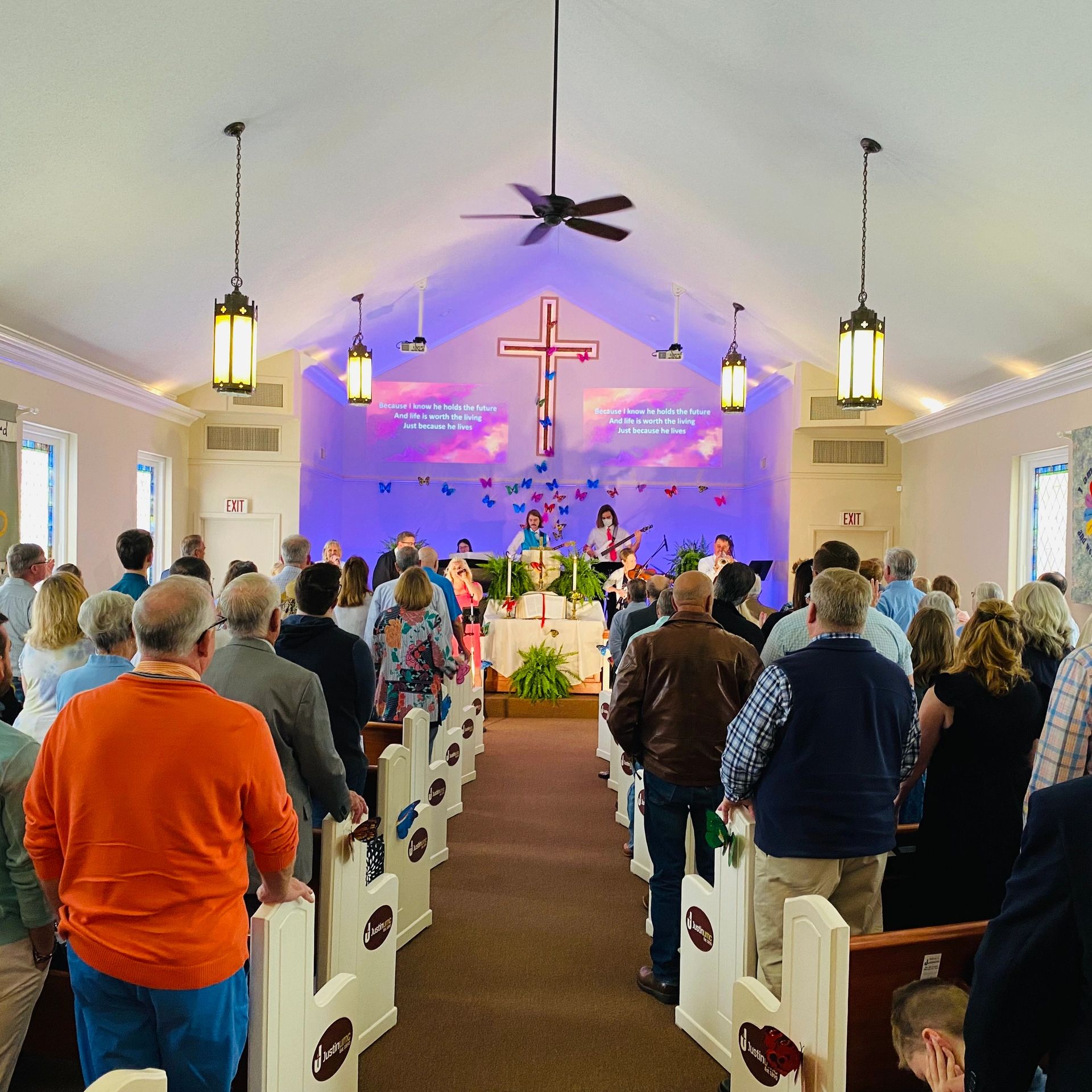 People standing and singing during worship.