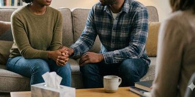 couple sitting on couch in mental health therapy office
