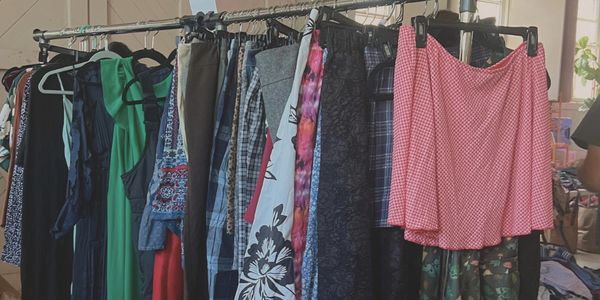 A rack of various colorful clothes hanging.