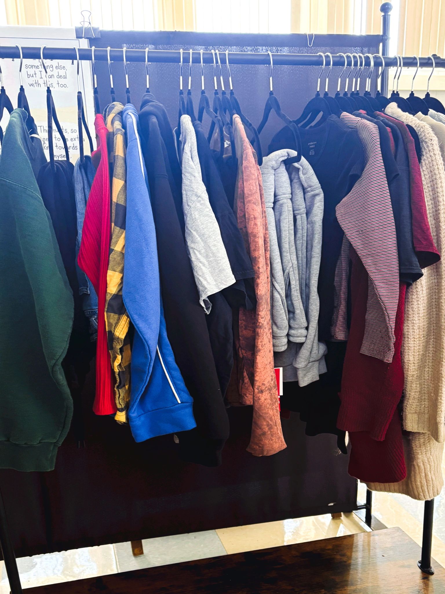 Colorful clothes hanging on a rack.