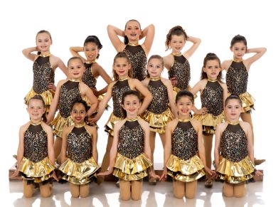 Group of young dancers in gold and black costumes posing.