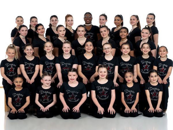 Group of young ballet performers in matching pastel Black costumes