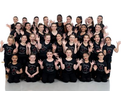 Group of young ballet performers in matching pastel Black costumes