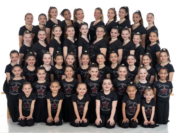 Group of young ballet performers in matching pastel Black costumes