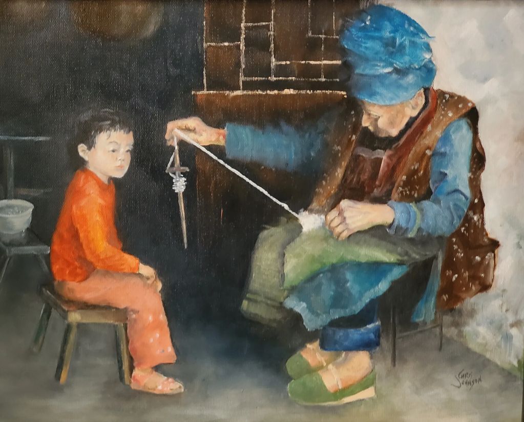 OLD WOMAN GIVING SPINNING LESSON TO A CHILD