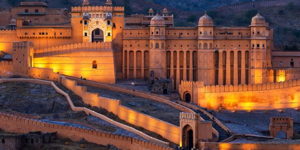 Illuminated Amber Fort in Rajasthan during twilight.