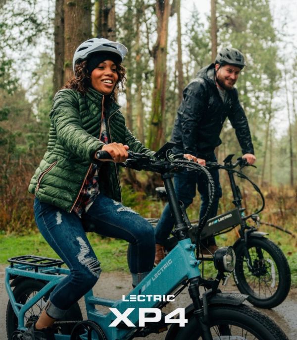 Two people enjoying a forest ride on Lectric XP4 electric bikes.