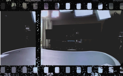 Empty film studio set with lighting and equipment.