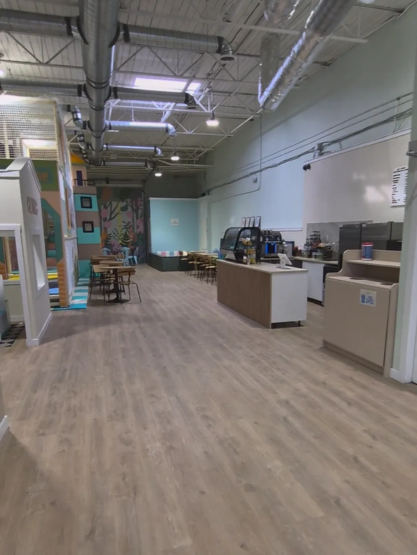 Indoor play area with seating and a small cafe counter.
