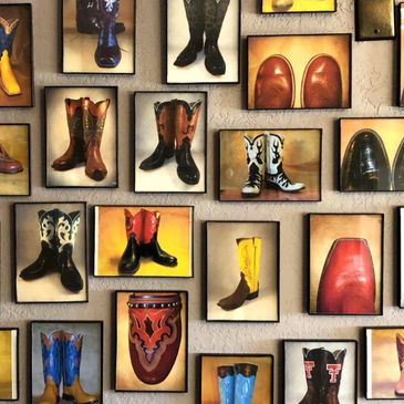Framed pictures of various cowboy boots on a wall.