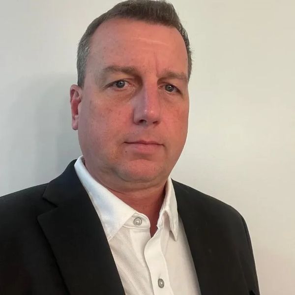 Man in business suit posing for a formal photo.