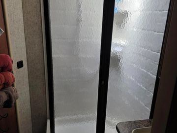 Frosted glass shower door in a bathroom.