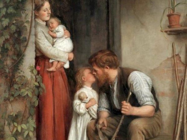 traditional catholic family gathered together with mother holding baby and child kissing father