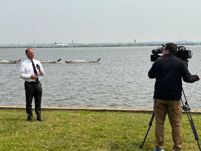 Local TV reporter doing stand-up against the backdrop of Sailing Marina after Chesaapeake Bay report