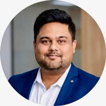 Professional man in a blue blazer and white shirt.