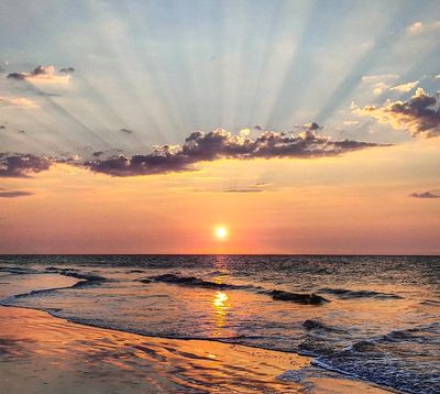 the sun setting over the ocean