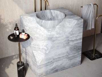 hand-carved marble pedestal sink made from a single block of natural stone for luxury interiors