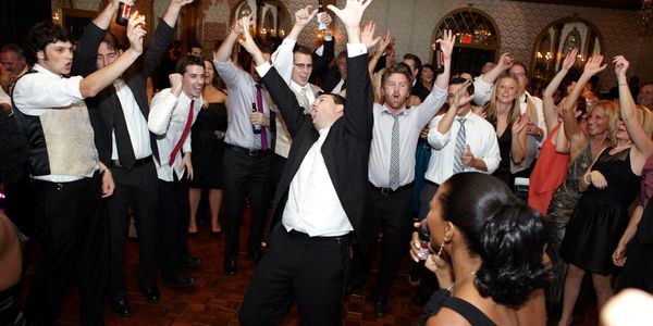 A group of people dancing and celebrating at a party.