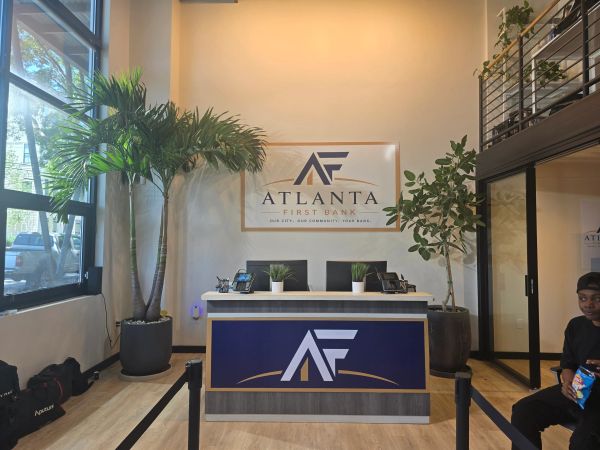 Reception area of Atlanta First Bank with plants and seating.