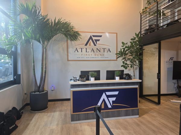 Reception area of Atlanta First Bank with plants and modern design.