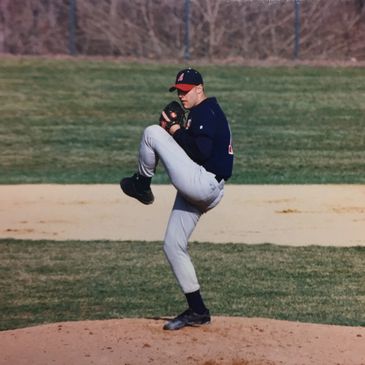 Chris Mitchell at DeSales University in mid-windup on the mound.
