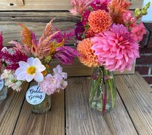 Dahlia’s in vases. The flowers are colorful. 